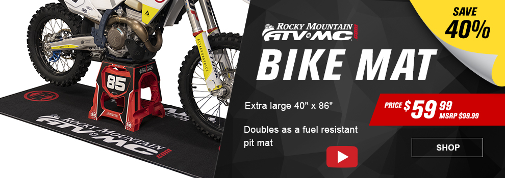 Rocky Mountain ATV/MC dot com, Bike Mat, Save 40 percent, Price $59 and 99 cents, MSRP $99 and 99 cents, the bike mat being used with a dirt bike sitting on a stand, Extra Large 40 inch by 86 inch, doubles as a fuel resistant pit mat, video available, link, shop
