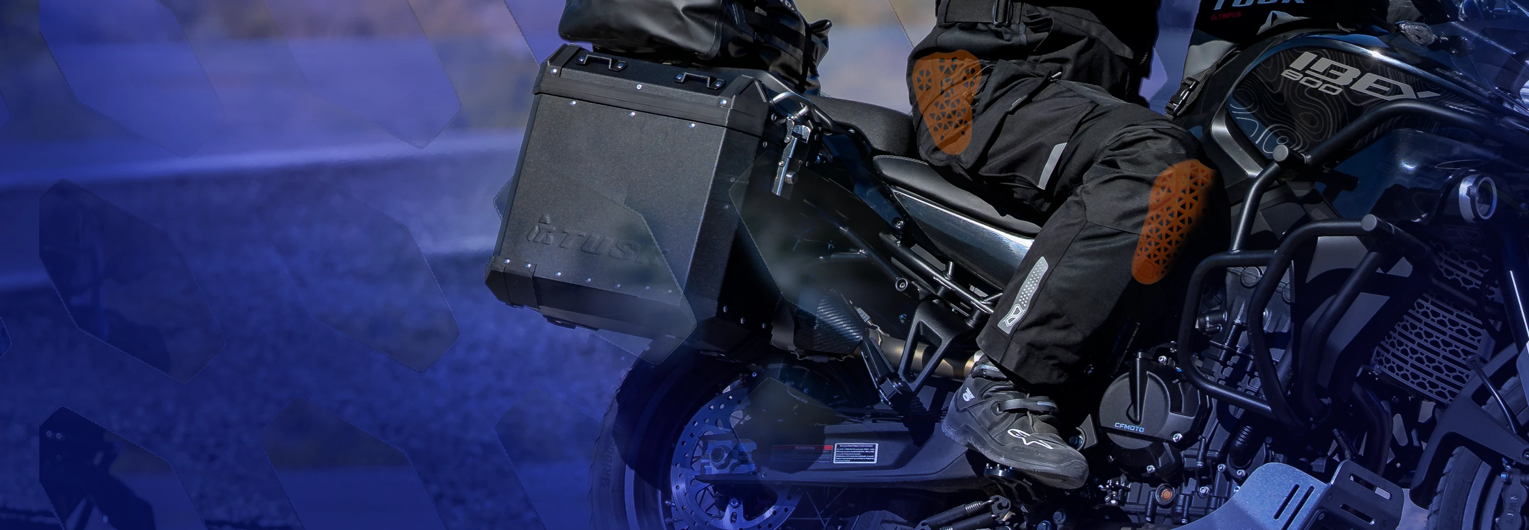 Rider wearing MSR Cryomesh pants with D3O armor at the knee and hip while seated on an adventure motorcycle