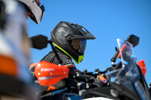 Profile of a rider getting ready to start riding, while on his bike.