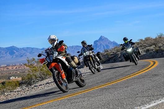 A group of riders turning on the highway while wearing the Cryomesh gear.