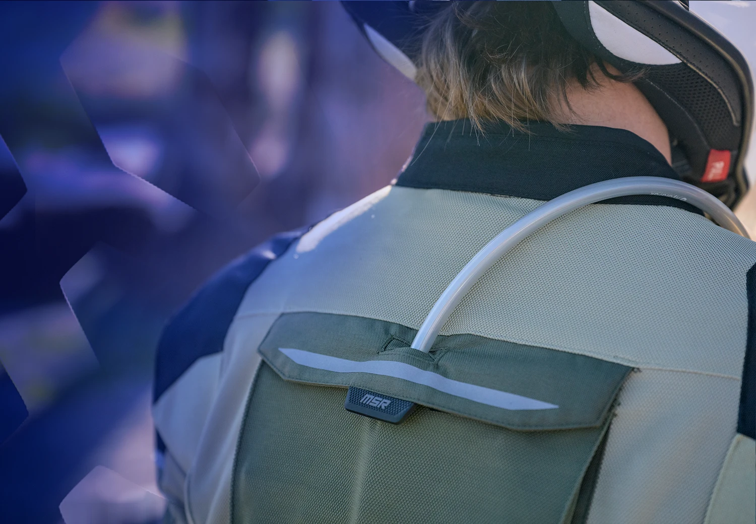 the back of the Cryomesh jacket with the hydration pack hose coming out the top
