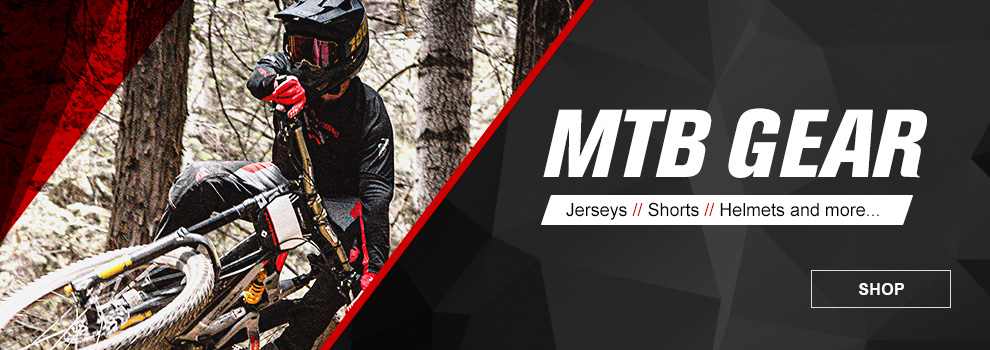 MTB Gear, jerseys, shorts, helmets and more. Link, shop. Person riding a mountain bike.